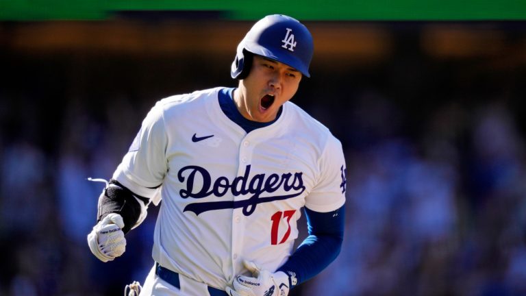 FILE - Los Angeles Dodgers' Shohei Ohtani celebrates as he heads to first for a solo home run during the ninth inning of a baseball game against the Colorado Rockies, Sunday, Sept. 22, 2024, in Los Angeles. (Mark J. Terrill/AP)