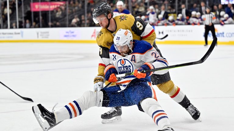 Edmonton Oilers centre Leon Draisaitl (29) and Vegas Golden Knights centre Jack Eichel (9) battle for the puck during the third period of an NHL hockey game Tuesday, Dec. 3, 2024, in Las Vegas. (David Becker/AP Photo)