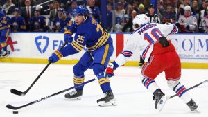 Buffalo Sabres defenceman Owen Power (25) is pressured by New York Rangers left wing Artemi Panarin (10) during the first period of an NHL hockey game Wednesday, Dec. 11, 2024, in Buffalo, N.Y. (Jeffrey T. Barnes/AP)