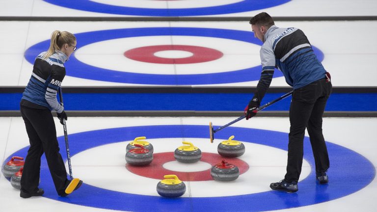 Brett Gallant, right, and Jocelyn Peterman discuss their options as they play Tyrel Griffith and Nancy Faye Martin at the Canadian mixed doubles curling championship gold medal game at Willie O'Ree Place in Fredericton, N.B. on Sunday, March 24, 2019. (Andrew Vaughan/CP)