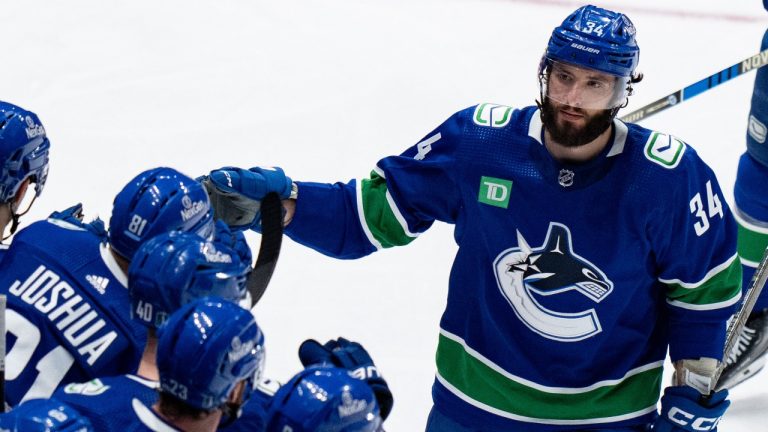 Vancouver Canucks' Phillip Di Giuseppe celebrates his goal against the Edmonton Oilers with his teammates during the second period in Game 5 of an NHL hockey Stanley Cup second-round playoff series, in Vancouver, on Thursday, May 16, 2024. (Ethan Cairns/CP)