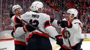 Ottawa Senators' Nick Jensen, left, celebrates after his goal with teammates Shane Pinto (12) and Thomas Chabot (72) during the third period of an NHL hockey game in Raleigh, N.C., Friday, Dec. 13, 2024. (Karl B DeBlaker/AP)