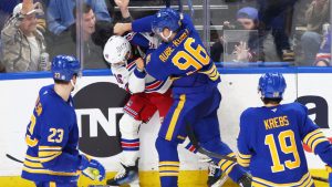 Buffalo Sabres right wing Nicolas Aube-Kubel (96) and New York Rangers center Vincent Trocheck (16) fight during the third period of an NHL hockey game Wednesday, Dec. 11, 2024, in Buffalo, N.Y. (Jeffrey T. Barnes/AP)