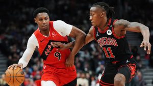 Toronto Raptors' RJ Barrett (9) protects the ball from Chicago Bulls' Ayo Dosunmu (11) during second half NBA basketball action in Toronto on Monday, December 16, 2024. (Frank Gunn/CP)