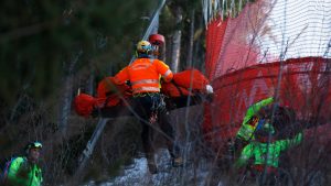 Medical staff are carrying France's Cyprien Sarrazin after crashing into protections net during an alpine ski, men's World Cup downhill training, in Bormio, Italy, Friday, Dec. 27, 2024. (Alessandro Trovati/AP)