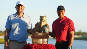 Scottie Scheffler, left, of the United States, and Tiger Woods, right, pose with the championship trophy after the final round of the Hero World Challenge PGA Tour at the Albany Golf Club in New Providence, Bahamas, Sunday, Dec. 8, 2024. (Fernando Llano/AP)