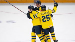 Sweden forward Otto Stenberg (25) and teammate Rasmus Bergqvist (2) celebrate Axel Sandin-Pellikka's (4) hat-trick goal during third period IIHF World Junior Hockey Championship preliminary round action against Slovakia, in Ottawa, Thursday, Dec. 26, 2024. (Spencer Colby/CP)