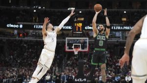 Boston Celtics' Jayson Tatum shoots as Chicago Bulls' Zach LaVine defends during the first half of an NBA basketball game. (Charles Rex Arbogast/AP)