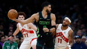 Boston Celtics' Jayson Tatum (0) keeps the ball away from Toronto Raptors' Bruce Brown (11) during the first half of an NBA basketball game, Tuesday, Dec. 31, 2024, in Boston. (Michael Dwyer/AP)