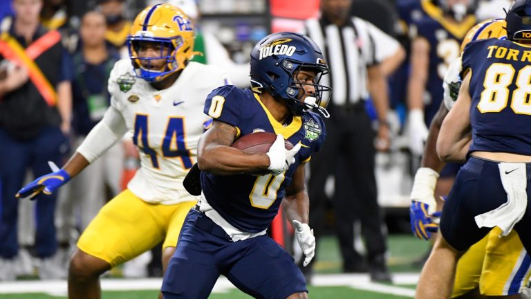 Toledo running back Jacquez Stuart (0) runs with the ball against Pittsburgh during the first half of the GameAbove Sports Bowl NCAA college football game, Thursday, Dec. 26, 2024, in Detroit. (Jose Juarez/AP Photo)