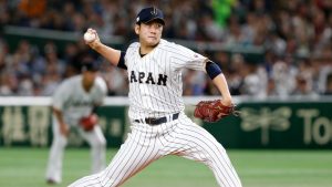 FILE - In this March 14, 2017, file photo, Japan starting pitcher Tomoyuki Sugano throws to a Cuba batter during the first inning of a second-round game at the World Baseball Classic in Tokyo.  (Toru Takahashi/AP)