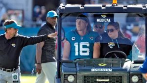 Jacksonville Jaguars quarterback Trevor Lawrence (16) leaves the field on a cart after getting injured on a late hit by Houston Texans linebacker Azeez Al-Shaair during the first half of an NFL football game Sunday. (John Raoux/AP)