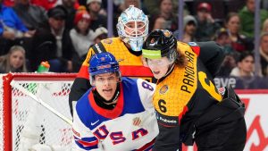 USA forward Brandon Svoboda (8), Germany defenceman Norwin Panocha (6) and teammate Nico Pertuch (1) look towards the puck during first period IIHF World Junior Hockey Championship preliminary round action in Ottawa on Thursday, Dec. 26, 2024. (Sean Kilpatrick/THE CANADIAN PRESS)