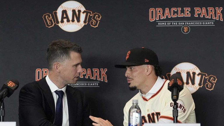 San Francisco Giants president of baseball operations Buster Posey, left, shakes hands with new shortstop Willy Adames during a news conference in San Francisco. (Jeff Chiu/AP)
