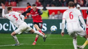 Leverkusen's Florian Wirtz, center, scores his side's second goal during the German Bundesliga soccer match between Bayer 04 Leverkusen and SC Freiburg in Leverkusen, Germany, Saturday, Dec. 21, 2024. (Marius Becker/dpa via AP)