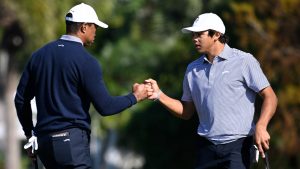 Charlie Woods, right, gets a fist bump from his father, Tiger Woods after making their putt on the fourth green during the first round of the PNC Championship golf tournament, Saturday, Dec. 21, 2024 in Orlando. (Phelan M. Ebenhack/AP)