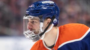 Edmonton Oilers' Zach Hyman (18) wears a face mask after being hit in the face with a shot from a teammate against the Florida Panthers during third period NHL action in Edmonton on Monday, December 16, 2024. (Jason Franson/CP)