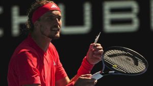 Alexander Zverev of Germany reacts as he holds a feather during his quarterfinal match against Tommy Paul of the U.S. during their quarterfinal match at the Australian Open tennis championship in Melbourne, Australia, Tuesday, Jan. 21, 2025. (Vincent Thian/AP)