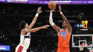 Oklahoma City Thunder guard Shai Gilgeous-Alexander (2) shoots the ball against Washington Wizards guard Jordan Poole, left, during the first half of an NBA basketball game Sunday, Jan. 12, 2025, in Washington. (Jess Rapfogel/AP)