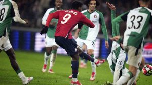 Lille's Jonathan David shoots to score his side's fourth goal during the Champions League opening phase soccer match between Lille and Feyenoord at the Stade Pierre Mauroy in Villeneuve-d'Ascq, outside Lille, northern France, Wednesday, Jan. 29, 2025. (Michel Euler/AP)