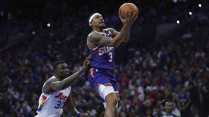 Phoenix Suns' Bradley Beal, right, goes up for a shot against Philadelphia 76ers' Adem Bona during the second half of an NBA basketball game, Monday, Jan. 6, 2025, in Philadelphia. (Matt Slocum/AP)