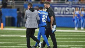 Detroit Lions cornerback Amik Robertson (21) is helped off the field against the Washington Commanders after being injured during the first half of an NFL football divisional playoff game, Saturday, Jan. 18, 2025, in Detroit. (Seth Wenig/AP)