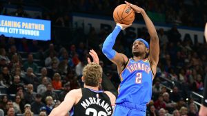 Oklahoma City Thunder guard Shai Gilgeous-Alexander (2) shoots over Utah Jazz forward Lauri Markkanen (23) during the first half of an NBA basketball game, Wednesday, Jan. 22, 2025, in Oklahoma City. (AP Photo/Kyle Phillips)