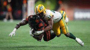 B.C. Lions' Jevon Cottoy (86) is tackled by Edmonton Elks' Elliott Brown after making a reception during the second half of a CFL football game, in Vancouver, on Thursday, June 27, 2024. The Edmonton Elks have released American defensive lineman Elliott Brown for him to pursue NFL opportunities. (Darryl Dyck/CP)