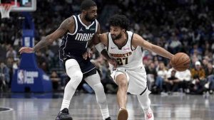 Denver Nuggets guard Jamal Murray (27) works against Dallas Mavericks guard Kyrie Irving (11) in the second half of an NBA basketball game in Dallas, Tuesday, Jan. 14, 2025. (Tony Gutierrez/AP)