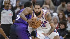 Sacramento Kings guard De'Aaron Fox (5) is guarded by Philadelphia 76ers forward Caleb Martin (16) during the first half of an NBA basketball game in Sacramento, Calif., Wednesday, Jan. 1, 2025. (Randall Benton/AP)