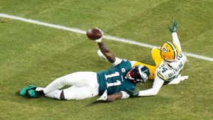 Philadelphia Eagle wide receiver A.J. Brown (11) holds up the ball after making the catch with Green Bay Packers cornerback Carrington Valentine (24) defending during an NFL wild-card playoff football game, Sunday, Jan. 12, 2025, in Philadelphia. (Chris Szagola/AP)