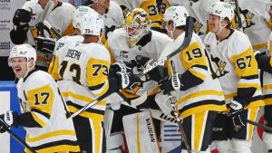 Pittsburgh Penguins goaltender Alex Nedeljkovic, centre, celebrates with teammates after scoring during the third period of an NHL game against the Buffalo Sabres, Friday, Jan. 17, 2025, in Buffalo, N.Y. (AP/Jeffrey T. Barnes)