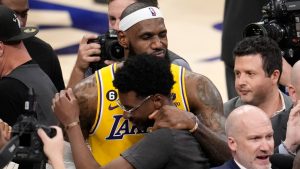 Los Angeles Lakers forward LeBron James is congratulated by his son Bryce Maximus after passing Kareem Abdul-Jabbar to become the NBA's all-time leading scorer during the second half of an NBA basketball game against the Oklahoma City Thunder Tuesday, Feb. 7, 2023, in Los Angeles.(AP Photo/Marcio Jose Sanchez)