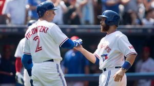 Toronto Blue Jays Russell Martin (right) is congratulated by Troy Tulowitzki after hitting a two-run homer off Detroit Tigers pitcher Alfredo Simon during fourth inning Major League baseball action in Toronto on Sunday, August 30, 2015. (Chris Young/CP)