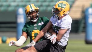 Edmonton Elks Loucheiz Purifoy (left) and Gavin Cobb (right) vie for the ball during training camp in Edmonton on Sunday May 14, 2023. (Jason Franson/CP)