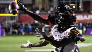 Ottawa Redblacks' Brandin Dandridge (37) breaks up a pass intended for Hamilton Tiger-Cats' Terry Godwin II (17) during second half CFL football action in Ottawa on Friday, September 8, 2023. (Matt Zambonin/CP)