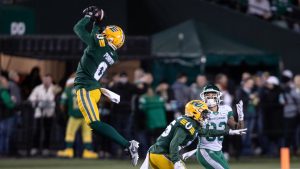 Saskatchewan Roughriders' Jerreth Sterns (83) and Edmonton Elks' Kordell Jackson (15) look for the ball as Loucheiz Purifoy (0) makes the interception during CFL action in Edmonton. (Jason Franson/CP)