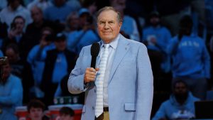 New North Carolina head football coach Bill Belichick speaks to the crowd at Dean Smith Center during halftime of an NCAA college basketball game, Saturday, Dec. 14, 2024. (AP Photo/Ben McKeown)