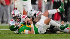 Ohio State defensive end Kenyatta Jackson Jr. (97) and safety Lathan Ransom (8) sack Oregon quarterback Dillon Gabriel (8) during the second half in the quarterfinals of the Rose Bowl College Football Playoff, Wednesday, Jan. 1, 2025, in Pasadena, Calif. (Mark J. Terrill/AP)