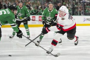 Ottawa Senators left wing Brady Tkachuk (7) shoots against Dallas Stars defenseman Ilya Lyubushkin during the second period of an NHL hokey game, Thursday, Jan. 2, 2025, in Dallas. (AP Photo/Julio Cortez)