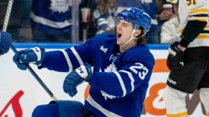 Toronto Maple Leafs left winger Matthew Knies (23) celebrates his hat trick goal with teammate Jake McCabe (22) as Boston Bruins defenceman Nikita Zadorov (91) reacts during third period NHL hockey action in Toronto, Saturday, Jan. 4, 2025. (Frank Gunn/CP)