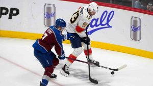 Colorado Avalanche defenceman Devon Toews, left, fights for control of the puck with Florida Panthers centre Sam Reinhart, right, in the first period of an NHL hockey game Monday, Jan. 6, 2025, in Denver. (David Zalubowski/AP)