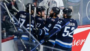 Winnipeg Jets' Adam Lowry (17), Nikolaj Ehlers (27), Alex Iafallo (9) and Dylan Coghlan (52) celebrate Ehlers' goal against the Colorado Avalanche during first period NHL action in Winnipeg on Saturday, January 11, 2025. (John Woods/CP)