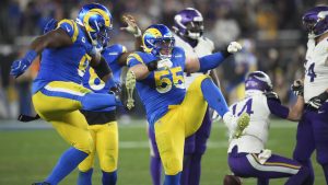 Los Angeles Rams defensive tackles Kobie Turner and Braden Fiske (55) celebrate a sack on Minnesota Vikings quarterback Sam Darnold (14) during the second half of an NFL wild card playoff football game, Monday, Jan. 13, 2025, in Glendale, Ariz. (Ross D. Franklin/AP)