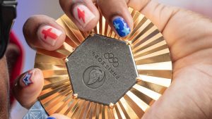 American Olympic champion Noah Lyles holds this gold medal before an interview in Paris, France, Sunday, Aug. 11, 2024. (AP Photo/Aurelien Morissard, File)