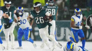 Philadelphia Eagles running back Saquon Barkley (26) runs the ball for a touchdown during the second half of an NFL football NFC divisional playoff game against the Los Angeles Rams on Sunday, Jan. 19, 2025, in Philadelphia. (Derik Hamilton/AP)