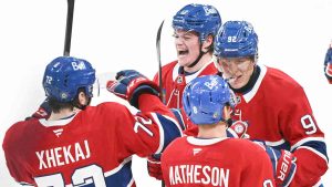 Montreal Canadiens' Patrik Laine (92) celebrates with teammates Cole Caufield (13), Mike Matheson (8) and Arber Xhekaj (72) after scoring against the New York Rangers during overtime period NHL hockey action in Montreal, Sunday, Jan. 19, 2025. (Graham Hughes/CP)