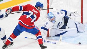 Montreal Canadiens' Kirby Dach (77) moves in on Tampa Bay Lightning goaltender Andrei Vasilevskiy during first period NHL hockey action in Montreal, Tuesday, January 21, 2025. (Graham Hughes/CP)