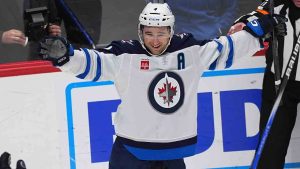 Winnipeg Jets defenceman Neal Pionk celebrates after scoring the winning goal in overtime of an NHL hockey game against the Colorado Avalanche Wednesday, Jan. 22, 2025, in Denver. (David Zalubowski/AP)