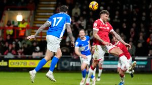 Birmingham City's Lyndon Dykes scores his side's first goal of the game, during the English Football League One soccer match between Wrexham and Birmingham City at the SToK Racecourse. (Nick Potts/PA via AP)